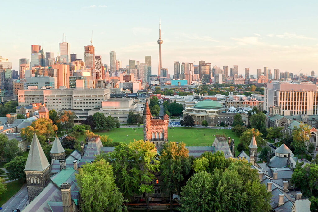 Aerial photo showing a lush green University of Toronto campus at dusk.