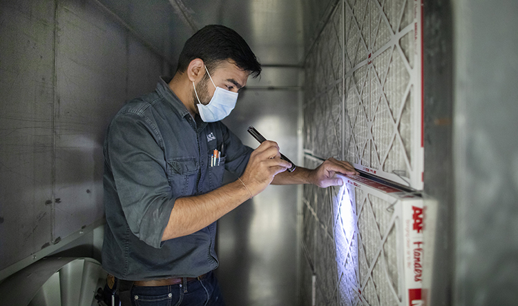 A building engineer maintains the HVAC system in the Myhal Centre for Engineering Innovation and Entrepreneurship.