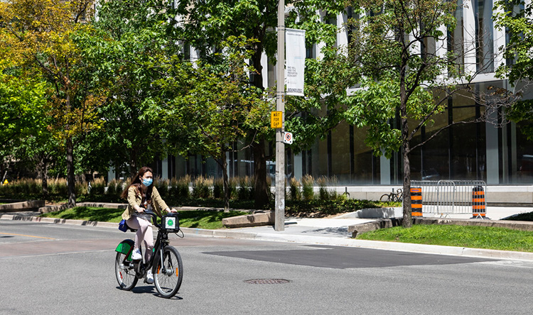 A student rides a bike share bicycle on campus.