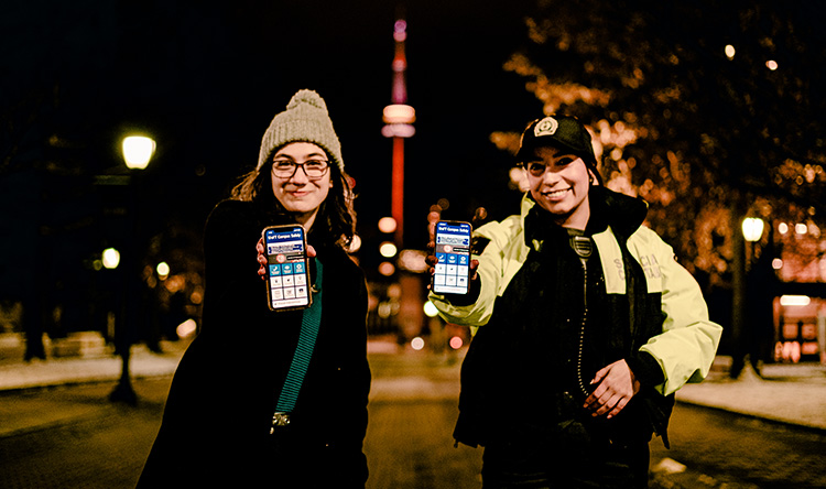 A student with Special Constable Veronica Martins show U of T Safety App on their mobile phones