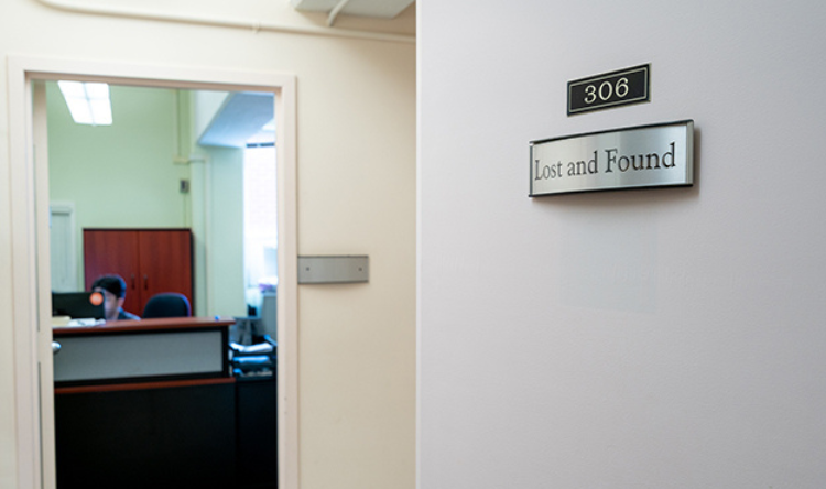 Lost and found sign on the door of the main caretaking office