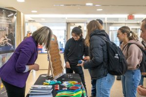Students gathered to play Plinko at the Fire Prevention Week information booth at Sidney Smith Hall