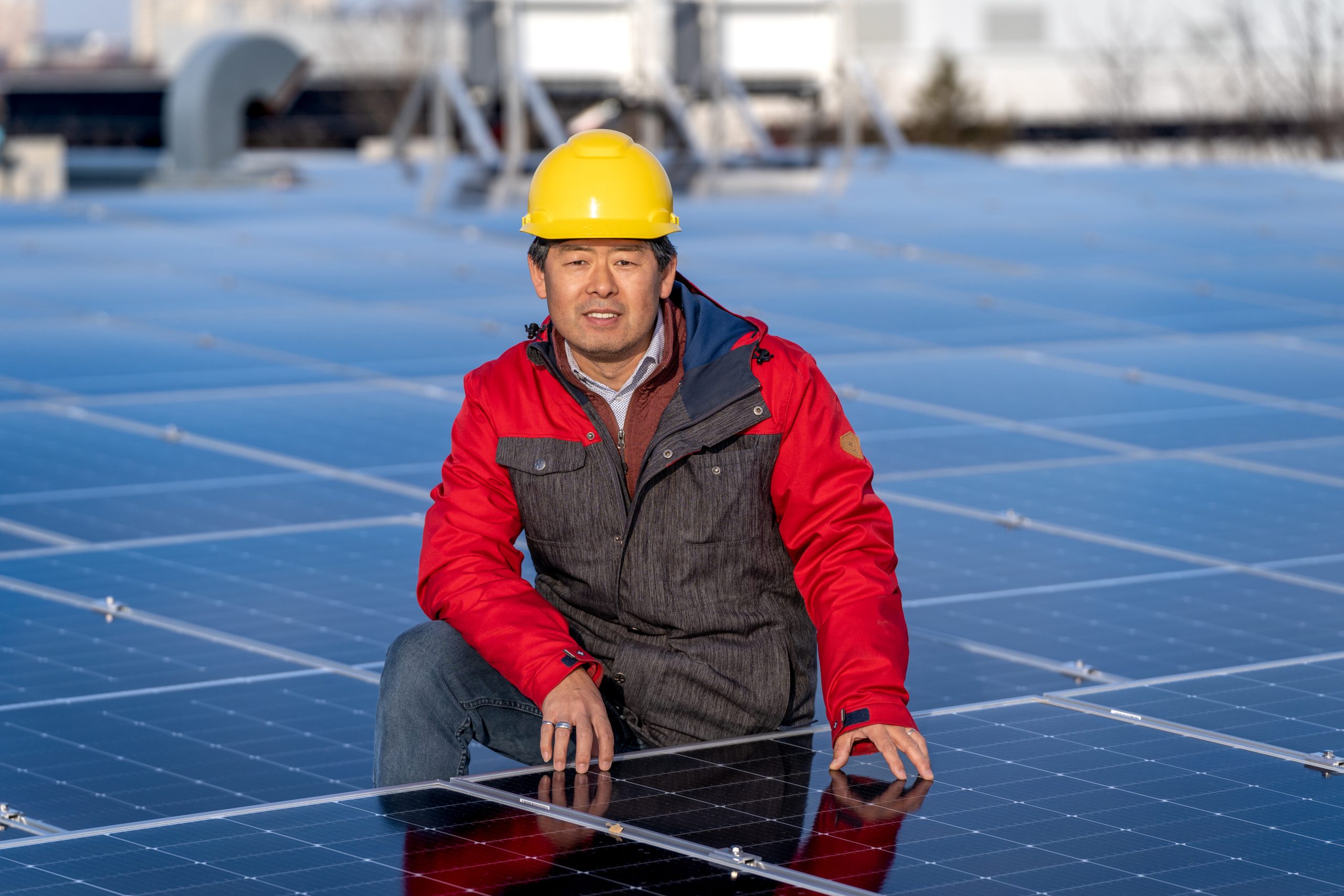 Larry Yang, Energy Manager, Sustainability Operations & Services, pictured amongst solar panels