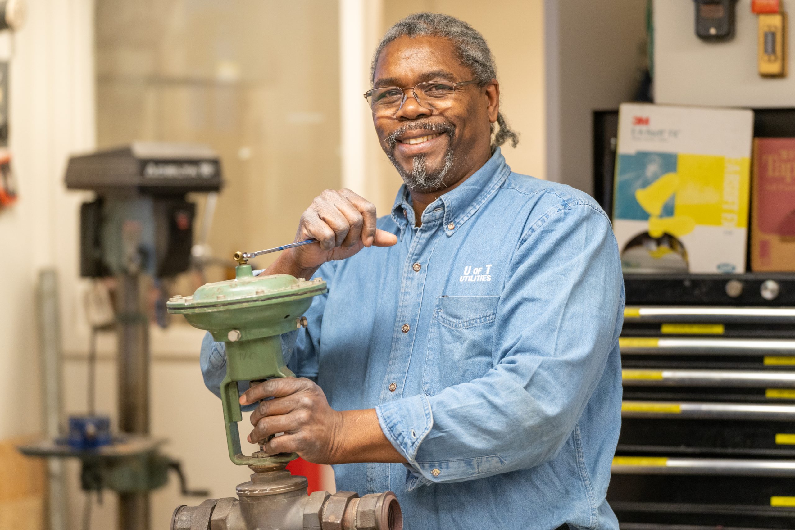 Lambert Adlam repairing a valve.