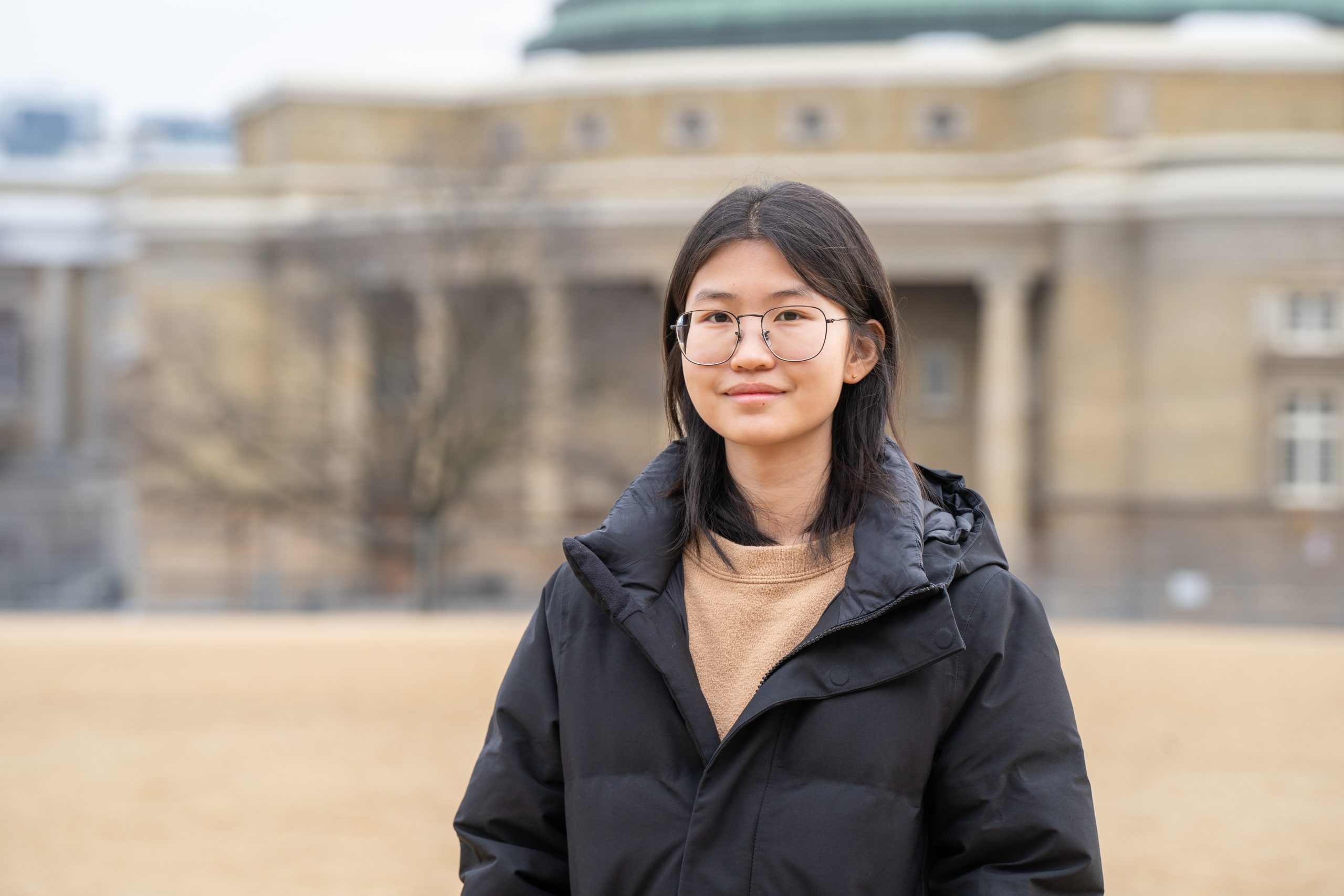 Christy Cui on front campus with Convocation Hall seen in the distance