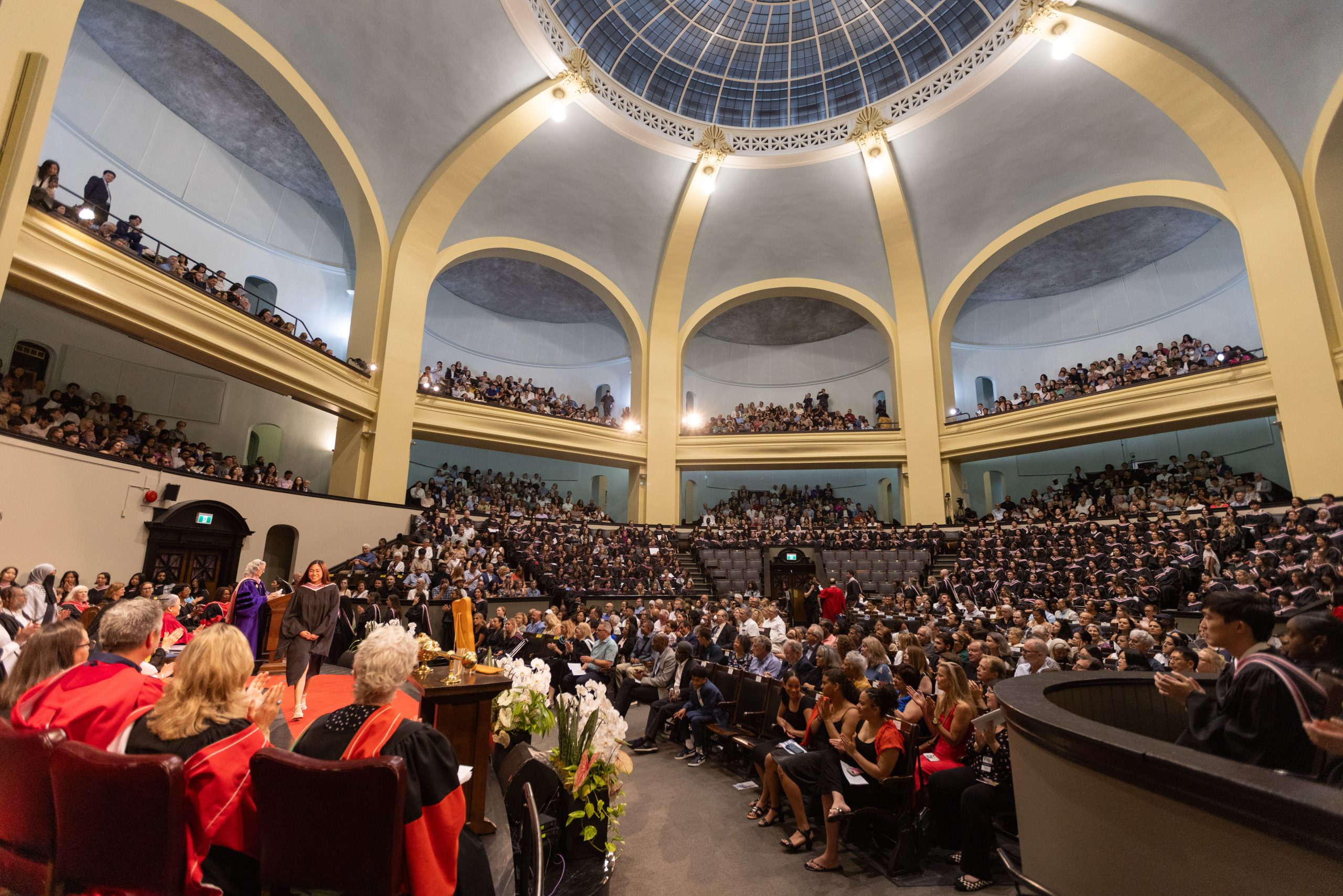 The interior of Convocation hall, full of students graduating and a packed audience.